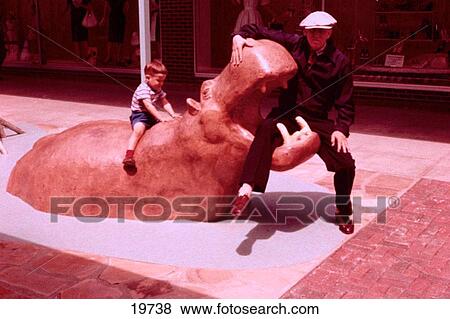 Grandfather and grandson playing on hippo statue View Large Photo Image Stock Photo - Grandfather and grandson playing on hippo statue. Fotosearch