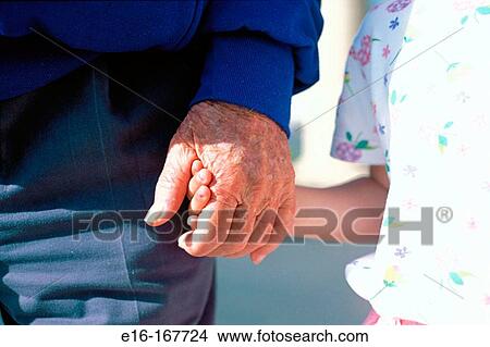 Grandfather holding hands with granddaughter View Large Photo Image Picture - Grandfather holding hands with granddaughter. Fotosearch