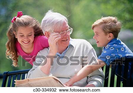 Grandfather reads to children. View Large Photo Image Stock Image - Grandfather reads to children.. Fotosearch