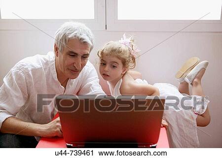 Stock Image - Grandfather teaching computer. Fotosearch