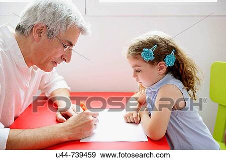 Grandfather teaching the granddaughter View Large Photo Image Stock Photo - Grandfather teaching the granddaughter. Fotosearch