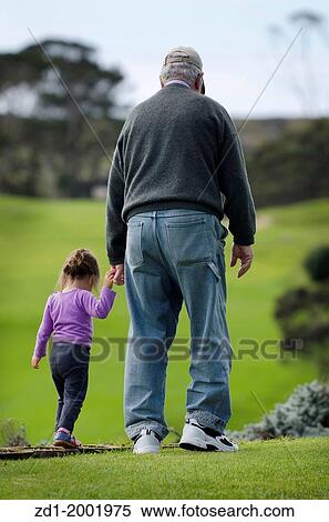 Grandfather walks and hold hands of his grand daughter. View Large Photo Image Stock Photography - Grandfather walks and hold hands of his grand daughter.. Fotosearch