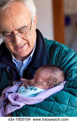 Grandfather with baby boy in his arms View Large Photo Image Picture - Grandfather with baby boy in his arms. Fotosearch