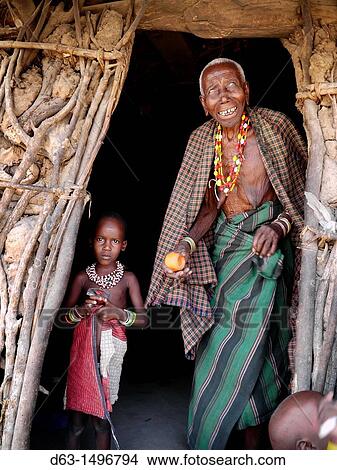 Picture - Grandmother and child in doorway of house, Watatulu tribesmen of Miyuguyu, Shinyanga district, Tanzania. Fotosearch