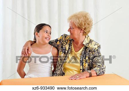 Stock Image - Grandmother and granddaughter hugging. Fotosearch