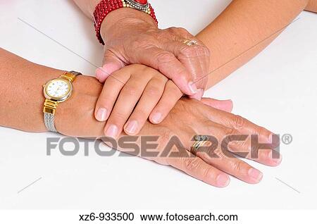 Stock Image - Grandmother and granddaugter's hands. Fotosearch