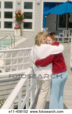 Grandmother & grandaughter hugging while walking on house deck, Montauk, Long Island, New York. USA View Large Photo Image Stock Image - Grandmother & grandaughter hugging while walking on house deck, Montauk, Long Island, New York. USA. Fotosearch