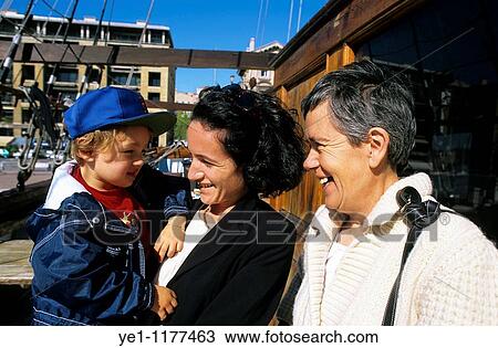 Grandmother, grandson and mother laughing together over a family joke. View Large Photo Image Stock Image - Grandmother, grandson and mother laughing together over a family joke.. Fotosearch