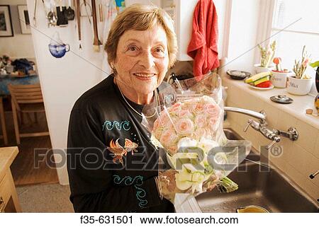 Grandmother in Kitchen with Flowers View Large Photo Image Stock Image - Grandmother in Kitchen with Flowers. Fotosearch