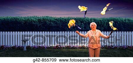 Grandmother juggling lit fire batons View Large Photo Image Stock Photo - Grandmother juggling lit fire batons. Fotosearch