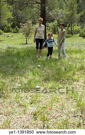 Grandmother playing a game of boules with her grandchildren, Provence, France View Large Photo Image Stock Image - Grandmother playing a game of boules with her grandchildren, Provence, France. Fotosearch