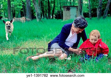 Grandmother sitting with her baby grandson in the grass View Large Photo Image Stock Image - Grandmother sitting with her baby grandson in the grass. Fotosearch
