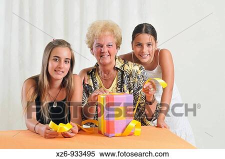 Grandmother wiht two granddaughters and his birthday present View Large Photo Image Stock Photography - Grandmother wiht two granddaughters and his birthday present. Fotosearch