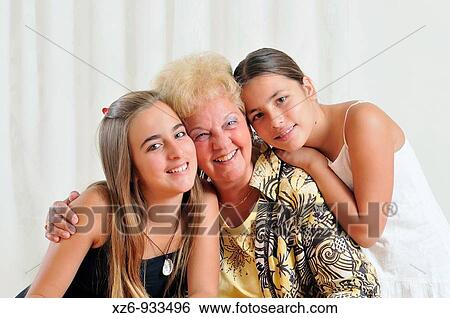 Grandmother wiht two granddaughters hugging View Large Photo Image Stock Photograph - Grandmother wiht two granddaughters hugging. Fotosearch