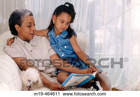 grandmother with grandaughter reading together View Large Photo Image Stock Image - grandmother with grandaughter reading together. Fotosearch