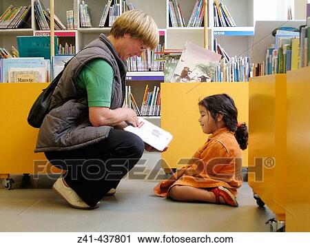 Grandmother with granddaughter in library View Large Photo Image Stock Image - Grandmother with granddaughter in library. Fotosearch