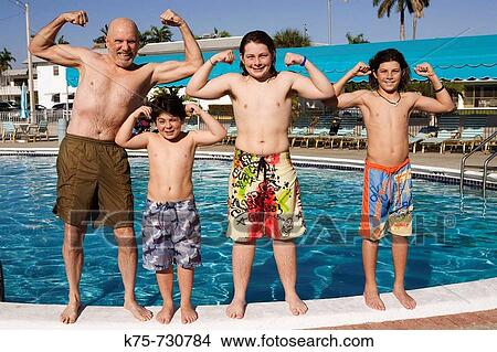 Grandpa and boys showing muscles at the pool View Large Photo Image Picture - Grandpa and boys showing muscles at the pool. Fotosearch