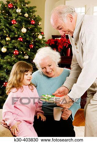 Grandparents and child at Christmas. View Large Photo Image Stock Image - Grandparents and child at Christmas.. Fotosearch