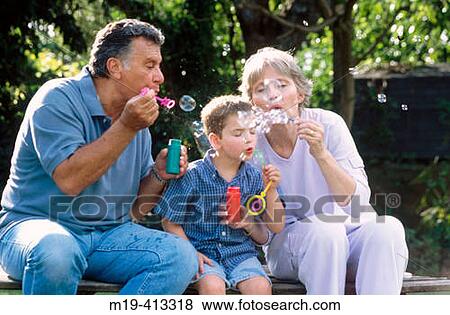 grandparents blowing bubbles with grandson View Large Photo Image Stock Photo - grandparents blowing bubbles with grandson. Fotosearch