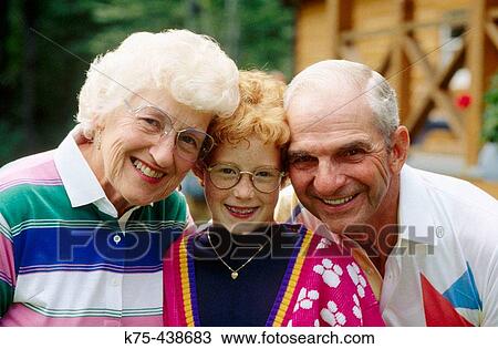 Stock Image - Grandparents with 10 year old. Fotosearch