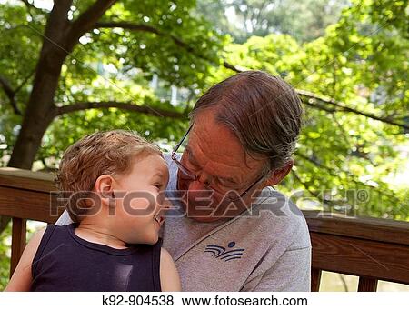 Grandson and grandfather looking at eachother. View Large Photo Image Stock Photo - Grandson and grandfather looking at eachother.. Fotosearch