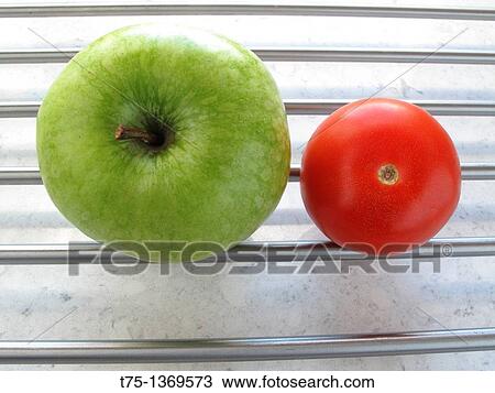 Granny Smith and tomato View Large Photo Image Stock Image - Granny Smith and tomato. Fotosearch