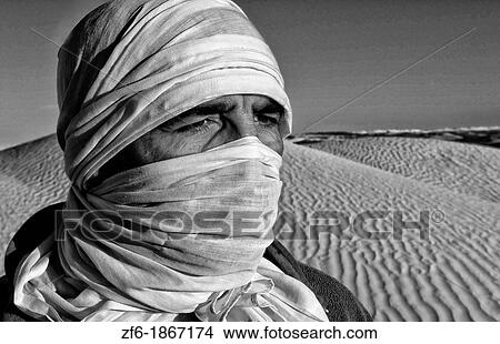 Graphic portrait of Bedouin man in Sahara Desert with sand in Douz Tunisia Africa View Large Photo Image Picture - Graphic portrait of Bedouin man in Sahara Desert with sand in Douz Tunisia Africa. Fotosearch