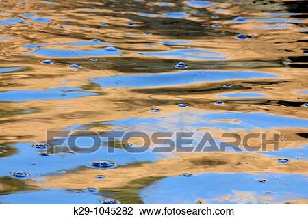 Grasses and sky reflected in standing waves of small creek View Large Photo Image Stock Image - Grasses and sky reflected in standing waves of small creek. Fotosearch