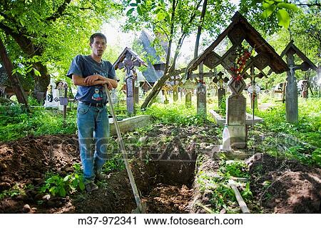 Gravedigger at Lemn din Deal church cemetery Ieud Maramures Romania MRR0901 View Large Photo Image Stock Image - Gravedigger at Lemn din Deal church cemetery Ieud Maramures Romania MRR0901. Fotosearch