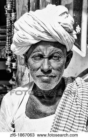 Great colorful portrait of local Hindu old man in turban in small village of Charu near Ranthambore in Rajasthan India View Large Photo Image Stock Image - Great colorful portrait of local Hindu old man in turban in small village of Charu near Ranthambore in Rajasthan India. Fotosearch
