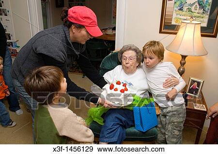Great grandchildren age 8 and 5 helping great grandmother age 93 blow out birthday candles Clitherall Minnesota MN USA View Large Photo Image Stock Photo - Great grandchildren age 8 and 5 helping great grandmother age 93 blow out birthday candles Clitherall Minnesota MN USA. Fotosearch