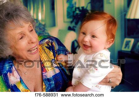 Stock Image - Great grandmother with her grand daughter and great grand daughter. Fotosearch