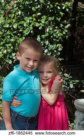Great happy portrait of sister age 3 and brother age 5 at home in yard hugging and caring for each other View Large Photo Image Stock Photography - Great happy portrait of sister age 3 and brother age 5 at home in yard hugging and caring for each other. Fotosearch