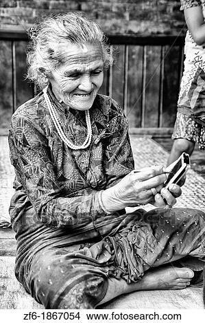 Great image of modern technology with old woman and new PDA computer in village of Bhaktapur a town near Kathmandu Nepal View Large Photo Image Picture - Great image of modern technology with old woman and new PDA computer in village of Bhaktapur a town near Kathmandu Nepal. Fotosearch
