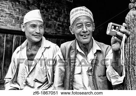 Great image of modern technology with local Hindu men and new camera self portrait in village of Bhaktapur a town near Kathmandu Nepal View Large Photo Image Stock Image - Great image of modern technology with local Hindu men and new camera self portrait in village of Bhaktapur a town near Kathmandu Nepal. Fotosearch