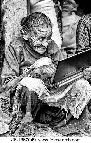 Great image of modern technology with old woman and new laptop computer in village of Bhaktapur a town near Kathmandu Nepal View Large Photo Image Stock Photo - Great image of modern technology with old woman and new laptop computer in village of Bhaktapur a town near Kathmandu Nepal. Fotosearch