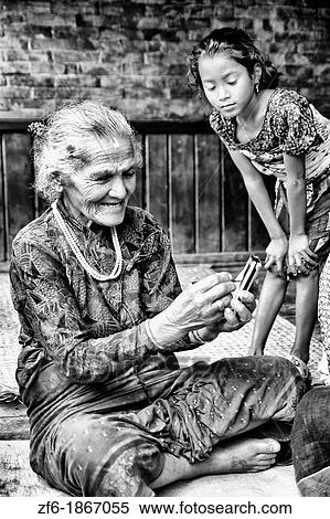 Great image of modern technology with old woman and new PDA computer in village of Bhaktapur a town near Kathmandu Nepal View Large Photo Image Stock Photography - Great image of modern technology with old woman and new PDA computer in village of Bhaktapur a town near Kathmandu Nepal. Fotosearch