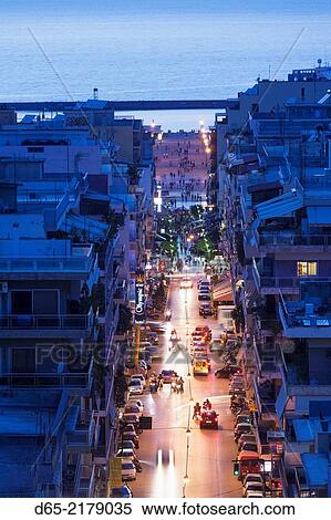 Stock Photography - Greece, Peloponese Region, Patra, elevated city view over Agios Nikolaos Street, dusk.. Fotosearch