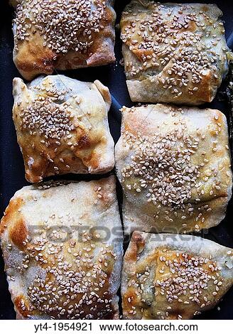 Stock Image - Greek Cuisine. Freash Cheese and Spinach Pies, Kalistsounia on Baking Tray.. Fotosearch