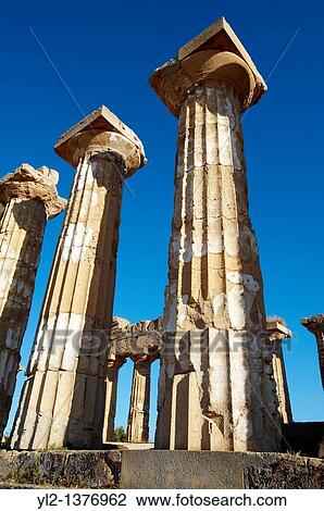 Stock Image - Greek Dorik columns at the ruins of Temple F at Selinunte, Sicily. Fotosearch