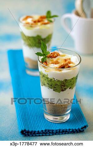Greek yogurt with kiwifruits and walnuts View Large Photo Image Stock Photo - Greek yogurt with kiwifruits and walnuts. Fotosearch