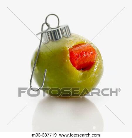 Green olive with hook attachment, as if it were a holiday ornament. On white background View Large Photo Image Stock Photo - Green olive with hook attachment, as if it were a holiday ornament. On white background. Fotosearch