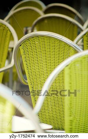 Picture - Green/yellow chairs in the street. Fotosearch