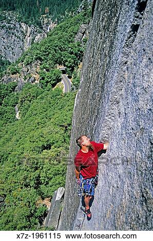 Stock Photography - Greg Moore rock climbing a route called Reeds Pinnacle Direct which is rated 5, 10 and located on Reeds Pinnacle in Yosemite Valley at Yosemite National Park in California.. Fotosearch