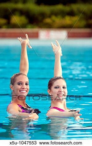 Greta Britain synchronised swimming team duet competitors, Jenna Randall 20, right and Olivia Allison 19, left Shot at the heated pool of 1930's Guildford Lido, Surrey UK View Large Photo Image Stock Image - Greta Britain synchronised swimming team duet competitors, Jenna Randall 20, right and Olivia Allison 19, left Shot at the heated pool of 1930's Guildford Lido, Surrey UK. Fotosearch