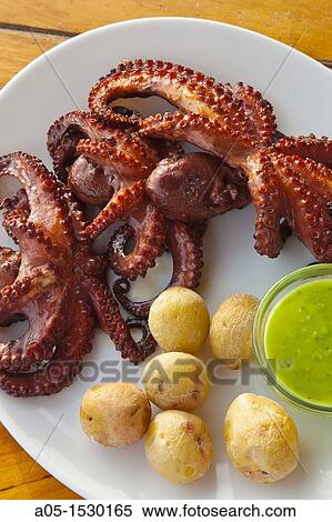 Grilled octopus with papas potatoes and green mojo Lanzarote Canary Islands Spain. View Large Photo Image Stock Photography - Grilled octopus with papas potatoes and green mojo Lanzarote Canary Islands Spain.. Fotosearch