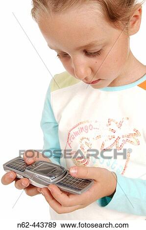 Grl playing with mobile phone. View Large Photo Image Stock Photo - Grl playing with mobile phone.. Fotosearch