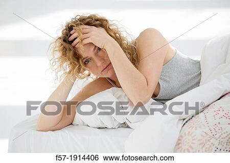 Groggy young woman in bed View Large Photo Image Stock Photograph - Groggy young woman in bed. Fotosearch