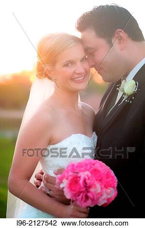 groom cuddling into her bride at sunset View Large Photo Image Stock Image - groom cuddling into her bride at sunset. Fotosearch