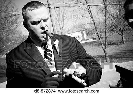 groom holding, smoking a cigar View Large Photo Image Picture - groom holding, smoking a cigar. Fotosearch